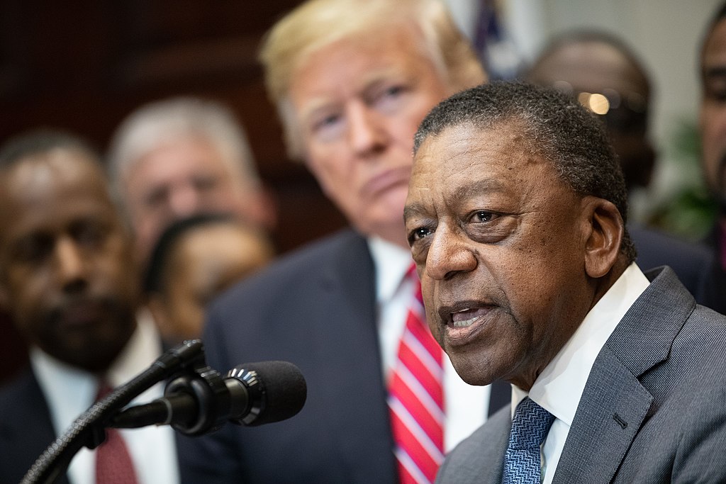 President Donald J. Trump listens as Bob Johnson , founder of the BET and RLJ Companies, addresses his remarks Wednesday, Dec. 12, 2018, at the signing ceremony of the Executive Order to establish the White House Opportunity and Revitalization Council in the Roosevelt Room of the White House. (Official White House Photo by Shealah Craighead